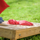 A cornhole bag flies toward the target
